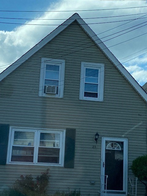 a yellow house with two windows and a door