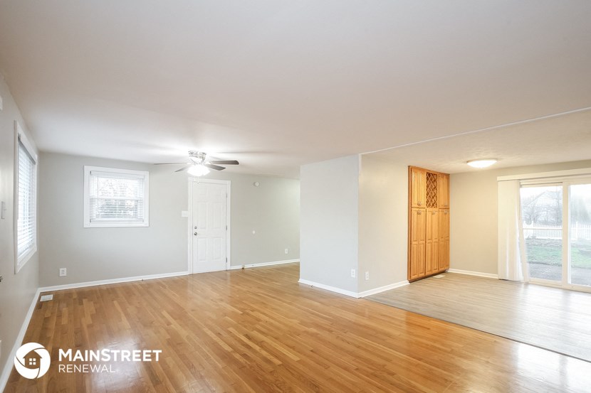 the living room and dining room with wood flooring