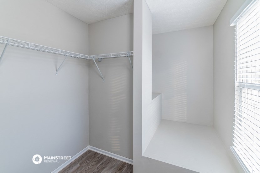 the spacious walk in closet in the master bedroom of an apartment