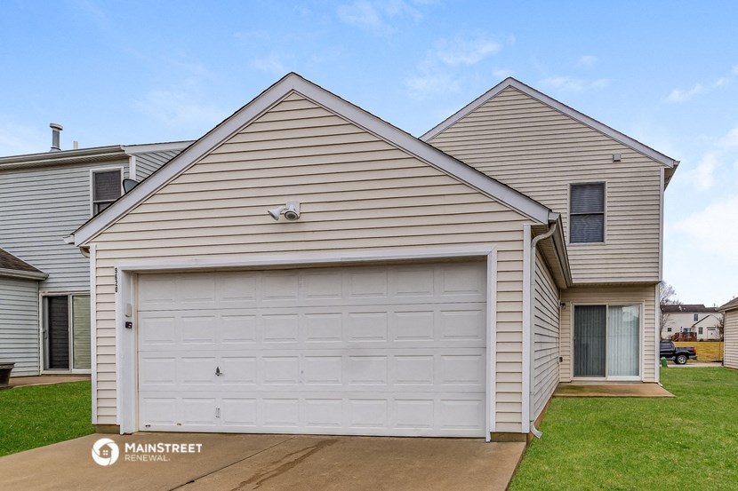 a white garage door on a white house