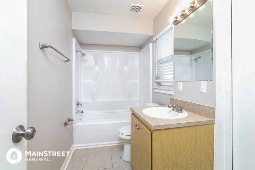 a bathroom with a sink and a shower and a toilet