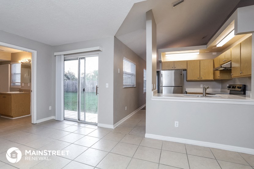 a large kitchen with a sliding glass door to the patio