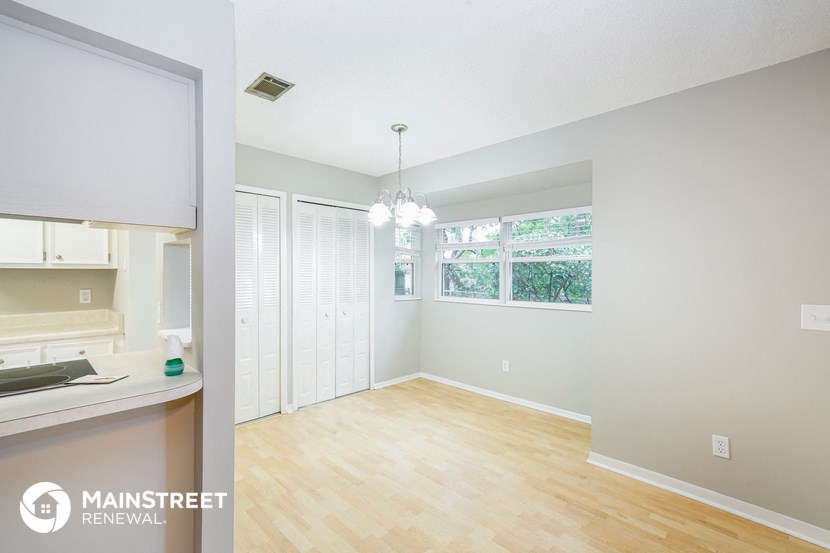 a kitchen and dining room with a wood floor and a window