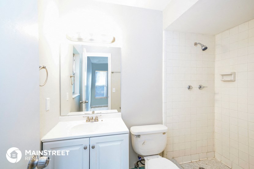 a bathroom with a sink toilet and a mirror