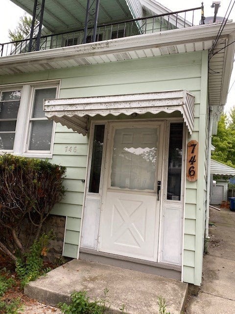 a blue house with a white door and a porch