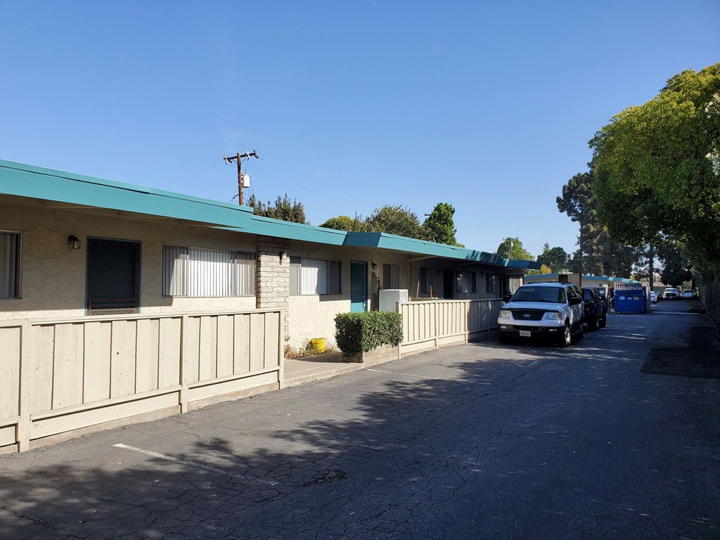 the front of a motel with a car parked outside