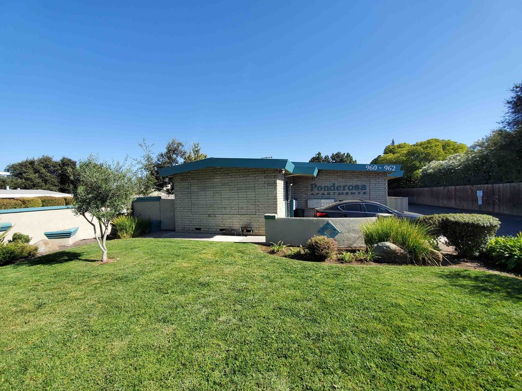 a house with a yard and a pool in front of it
