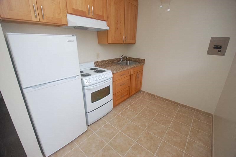 a kitchen with a white stove and a refrigerator