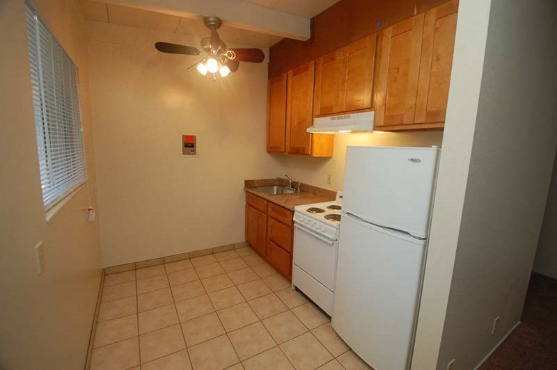 a kitchen with a stove and a refrigerator