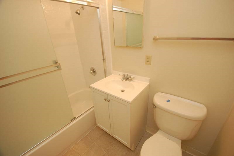 a bathroom with a toilet sink and a shower