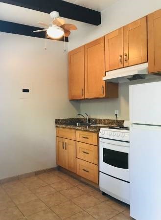 a kitchen with a white stove and a refrigerator
