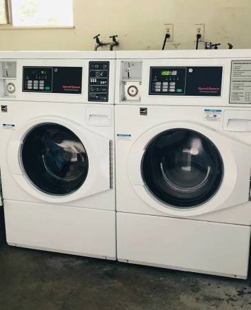 three washing machines are lined up next to each other