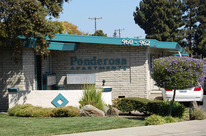 the front of a building with a car parked in front of it