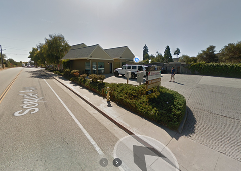 a street scene with a truck parked in front of a house