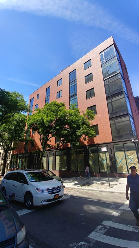 a tall building with a car parked in front of it