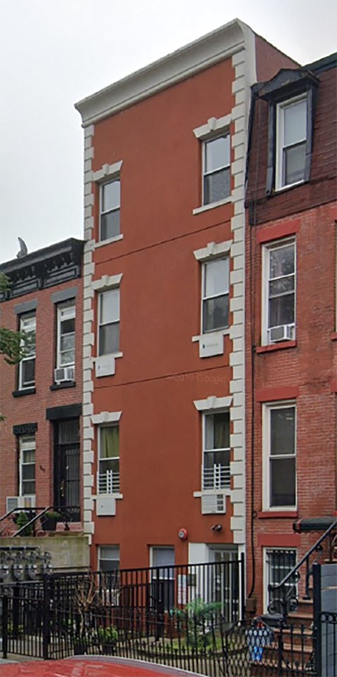 a large red brick building with windows on the side of it