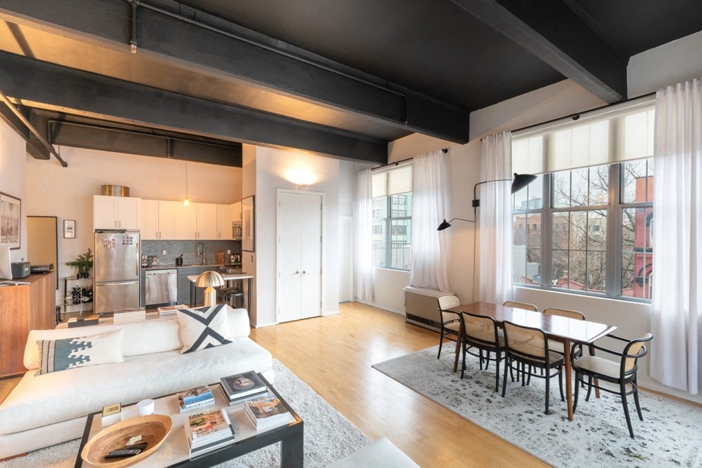 a living room with a couch and a table with chairs