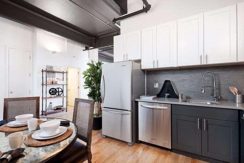 a kitchen with stainless steel appliances and a dining table