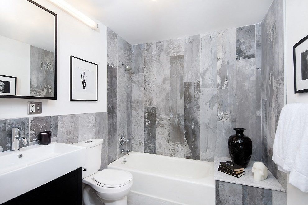 a bathroom with a toilet and a tub and a sink