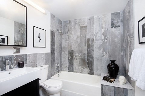 a bathroom with a toilet and a tub and a sink
