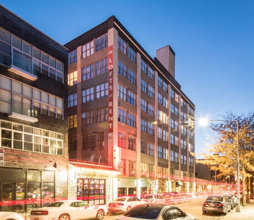 a city street with cars parked in front of a building