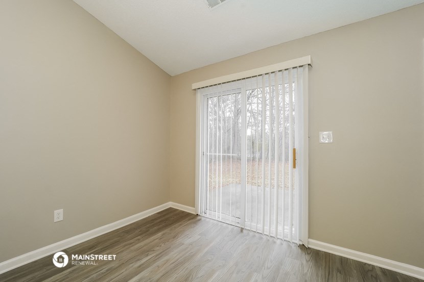 the living room of an apartment with a sliding glass door