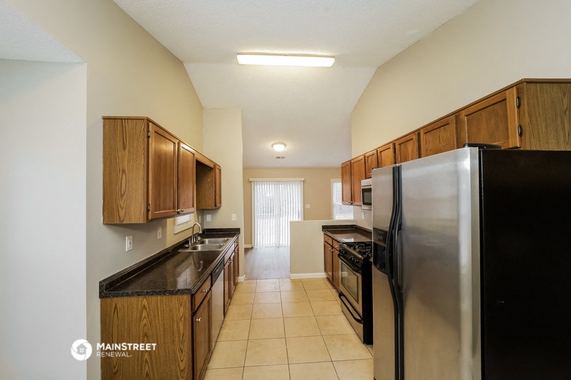 a kitchen with stainless steel appliances and wooden cabinets