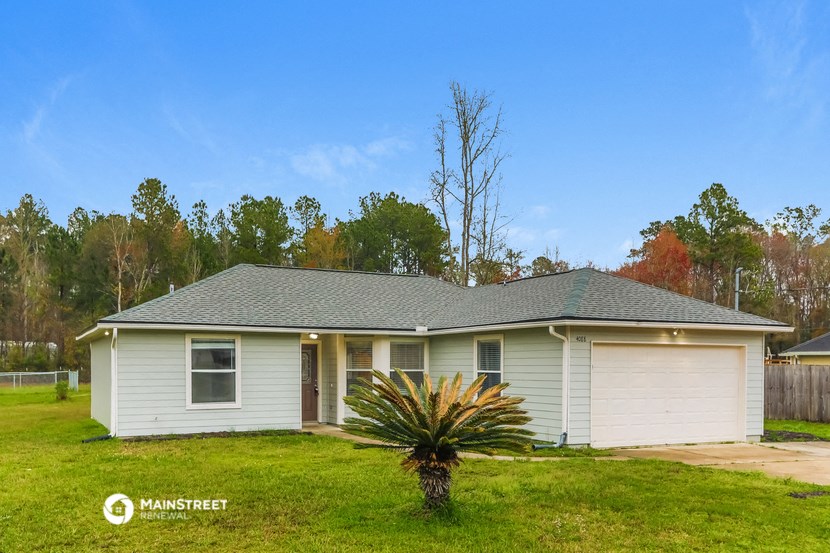 a white house with a palm tree in front of it