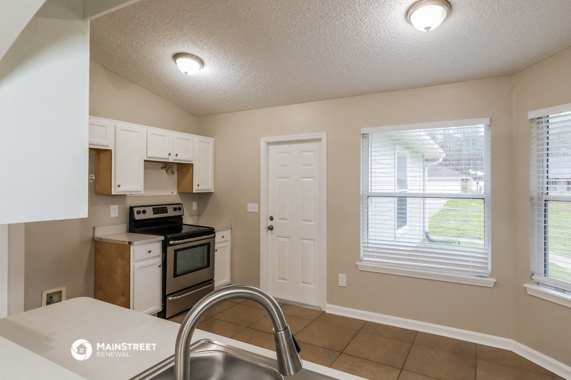 a kitchen with a sink and a stove and a window
