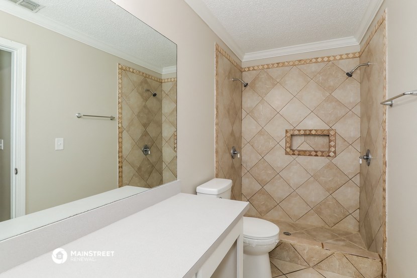 a bathroom with a shower and a sink and a toilet