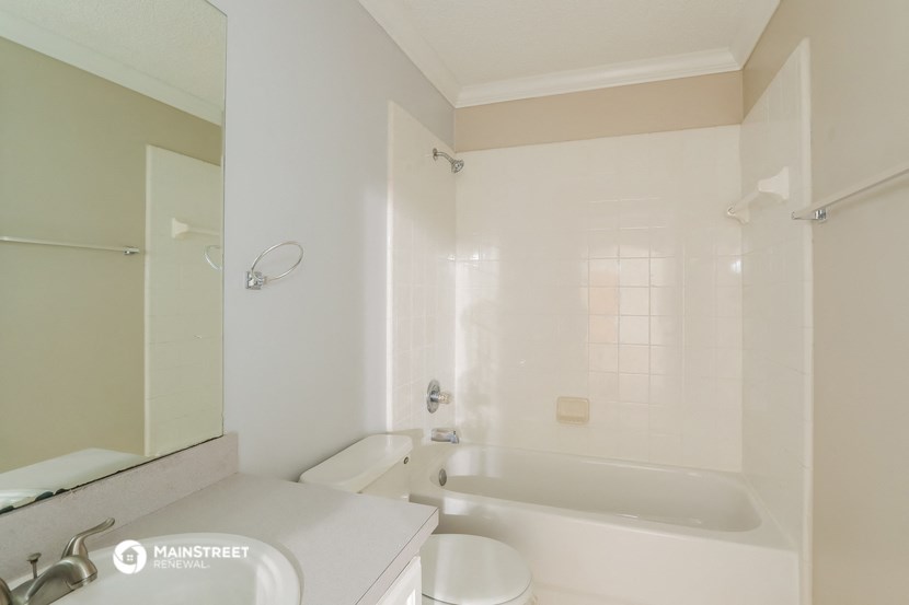 a bathroom with a tub and a sink and a toilet