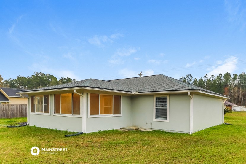 the exterior of a house with a green lawn and a blue sky
