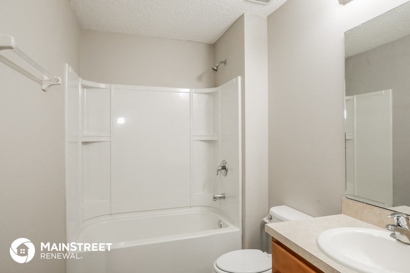 a bathroom with a shower and a sink and a toilet