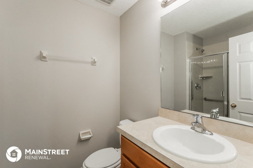 a bathroom with a sink and a mirror and a toilet