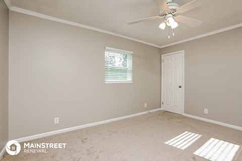 the master bedroom is spacious and has a ceiling fan