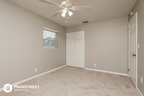 the master bedroom is spacious and has a ceiling fan