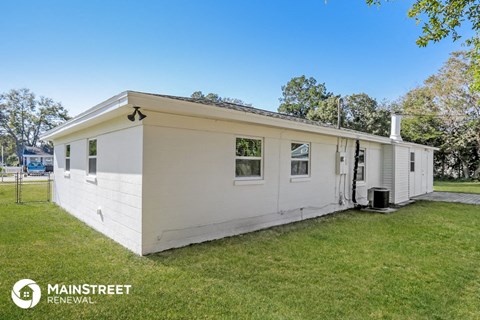 the exterior of a white mobile home in a grassy yard