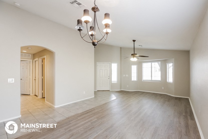 the living room and dining room of an open floor plan
