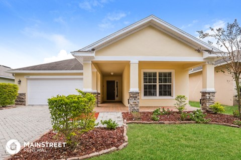 a home with a driveway and a lawn