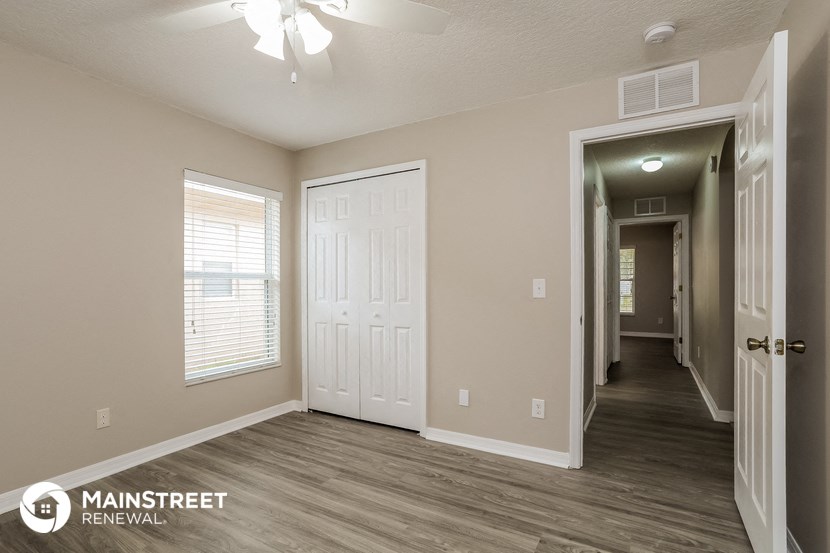 the spacious living room and hallway of a 560 sq ft home
