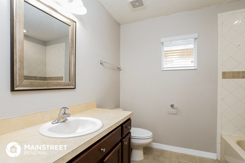 a bathroom with a sink and a toilet and a mirror