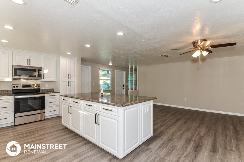 a kitchen with white cabinets and a counter top