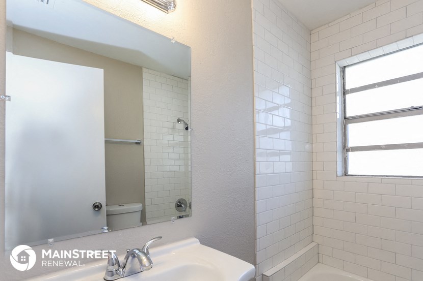 a bathroom with a sink and a mirror and a shower
