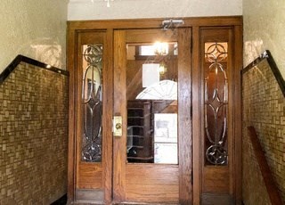 a wooden door with glass windows in a building