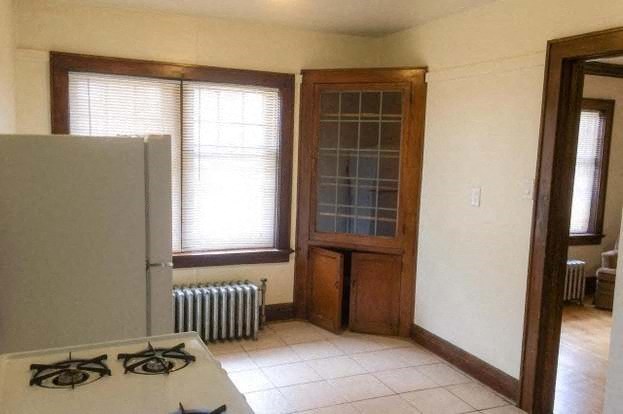 an empty kitchen with a stove and a refrigerator
