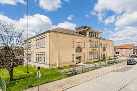 a large brick building on the side of a street