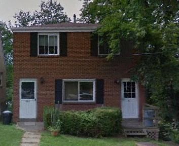 a red brick house with white doors and windows