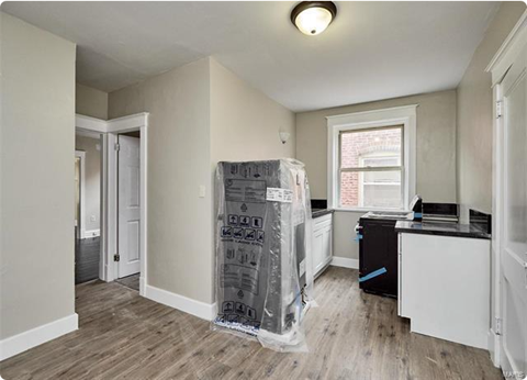 an empty living room with a plastic wrap on the floor