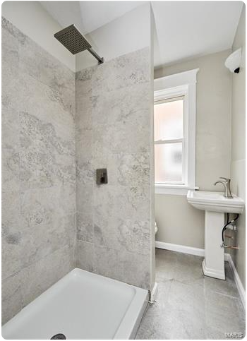 a bathroom with a tub and a sink and a window