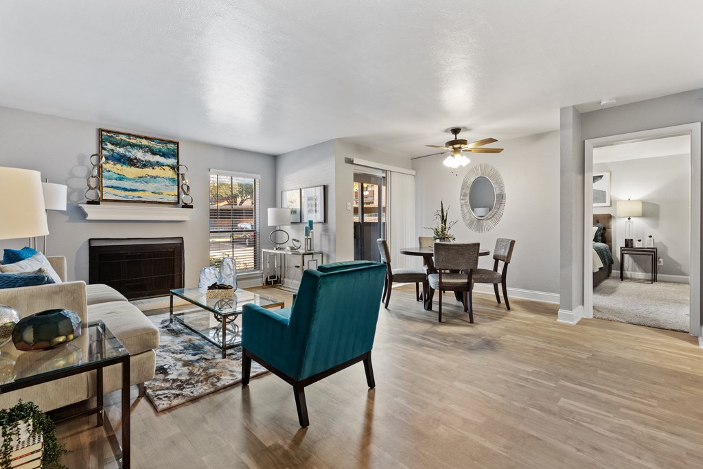 a living room with a fireplace and a dining room